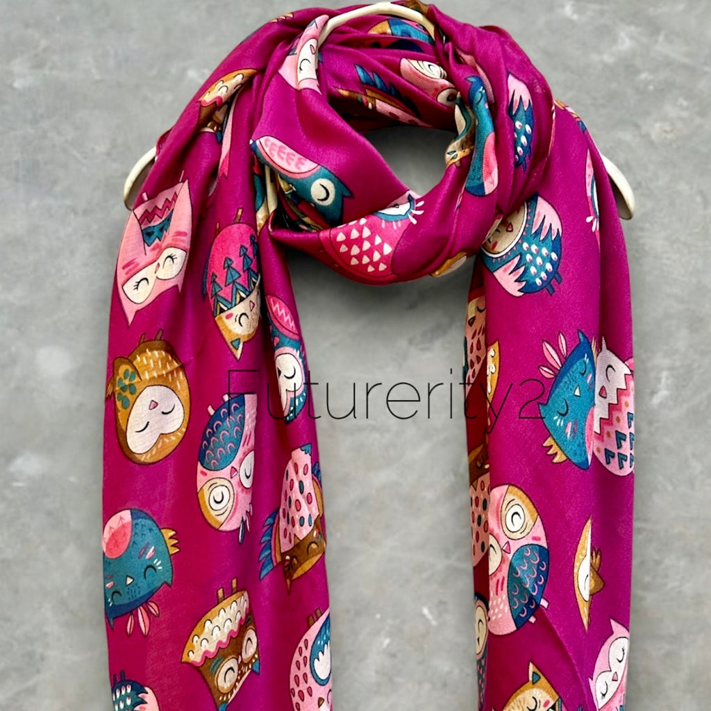 A pink scarf with a repeating pattern of colorful owls. The owls are in various poses and have different designs. The scarf is made of a soft, lightweight fabric and is perfect for adding a touch of whimsy to any outfit.